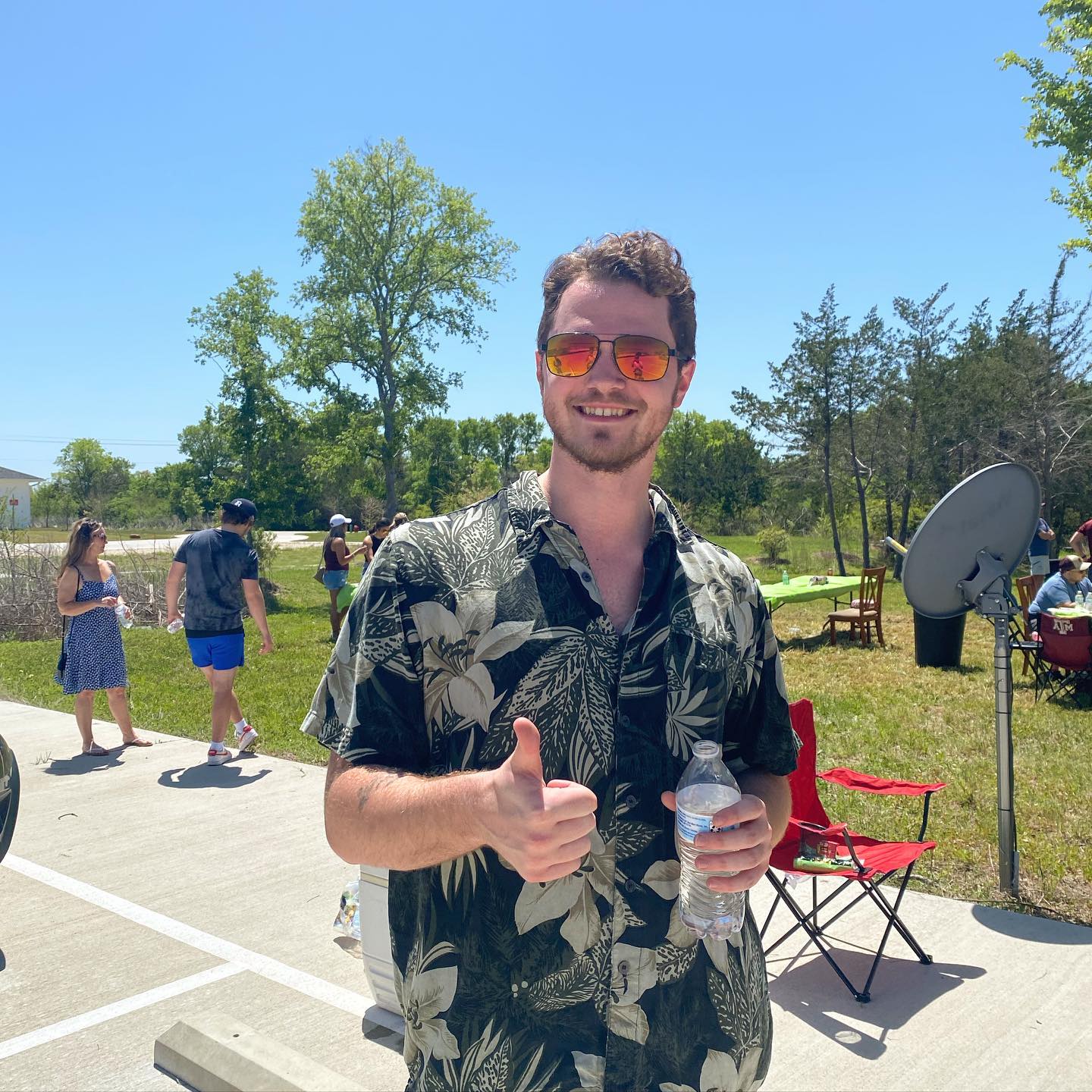 Student giving a thumbs up at the crawfish boil.